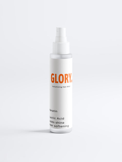 A white spray bottle of GLORY Volumizing Hair Mist with orange and black text, set against a clean white background.
