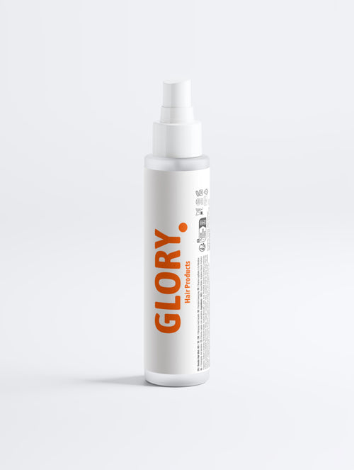 A white cylindrical spray bottle with a white pump dispenser, featuring the brand name 'GLORY' printed vertically in orange on the front label, set against a clean, light gray studio background.
